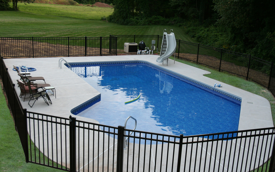 Maintenance-free fence installation bordering a completed hardscape